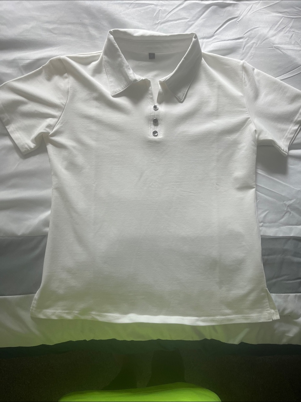 Women’s white polo shirt.